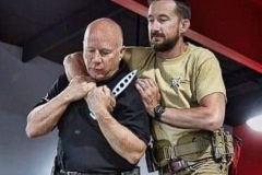 Woman pulls a gun from her swanky purse while the thief stood in the back. Conceal carry weapon for protection themselves concept. Selective focus.