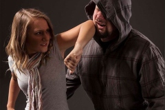 Woman pulls a gun from her swanky purse while the thief stood in the back. Conceal carry weapon for protection themselves concept. Selective focus.